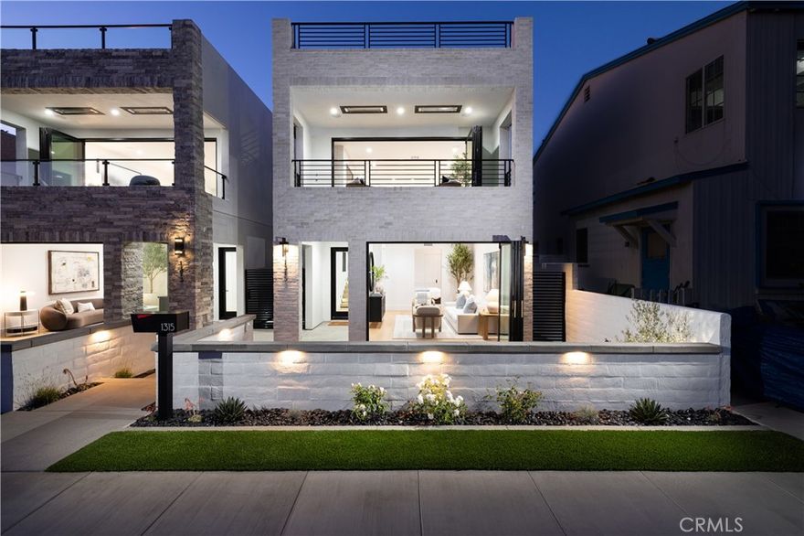 1315 Ocean Avenue is a striking blend of coastal sophistication and modern design, ideally located just steps from the sand and the vibrant boutiques and cafés of Main Street. This newly constructed 3-bedroom, 4-bathroom residence spans 2,796 square feet and showcases a reverse floor plan that elevates the main living areas to capture natural light and ocean breezes. A chef’s kitchen with Thermador appliances, a waterfall-edge island, and custom cabinetry flows seamlessly into expansive living and dining spaces, where 14-foot stacking glass doors open to a covered terrace with built-in heaters for effortless indoor-outdoor living. The primary suite offers a spa-like bath with a soaking tub, dual vanities, and a generous walk-in closet. Downstairs, a glass-and-steel staircase leads to two additional en suite bedrooms and a versatile bonus room ideal for a media space, home gym, or optional fourth bedroom. Atop the home, an 800-square-foot rooftop deck offers panoramic views stretching from the coastline to Catalina Island. Smart home wiring, solar panels, and a private elevator serving the two main floors add convenience, while the 462-square-foot garage features a 400-amp electrical system ready for EV charging, high ceilings for car lifts, and plumbing for a secondary laundry and outdoor shower. Ideally located in Seal Beach, Orange County’s northernmost coastal town, these homes offer convenient access to both Los Angeles and Orange County. Just minutes from the 405 freeway, Seal Beach is adjacent to Huntington Harbour, Seal Beach Marina, Long Beach Harbor, and Long Beach Airport. Whether you’re commuting, boating, or traveling, this location connects you seamlessly to it all - while still offering the charm, privacy, and walkability of a classic beach town.
