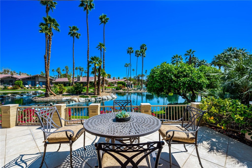Welcome to The Lakes Country Club! This lakefront expanded Laramie floor plan with two bedrooms, a den, three and a half bath home is sure to delight you. From the moment you enter the paver courtyard with planters and inviting landscape, you will feel welcomed. Once inside your eyes are immediately drawn to the special, private waterfront. patio. Enjoy blissful morning sunrises and dazzling water views, producing your own piece of paradise. This private outdoor oasis is perfect for entertaining or quite relaxation and even offers a built-in grill. Inside, the soaring, vaulted ceilings create an open feeling, further enhanced by an expanded dining room that opens to the great room. The kitchen is tastefully finished with granite countertops and stainless appliances. All the bathrooms have been recently updated in neutral, contemporary tile showers and quartz countertops. A large walk-in closet has been added to the primary suite which offers offering flexibility for many uses. This desirable home comes complete with a golf cart garage and golf cart. Schedule your private showing today so that you can start to enjoy The Lakes Lifestyle! The Lakes Country Club offers a robust schedule of social and fitness activities at the exquisite Clubhouse and Health and Wellness Center. Enjoy Tennis, Pickleball or Pop Tennis, Bocce or the 44 community pools and spas. For golfers, the Club offers membership options for the 27 hole championship golf course. Don’t miss this rare opportunity – schedule your private tour today and make your dream home a reality!