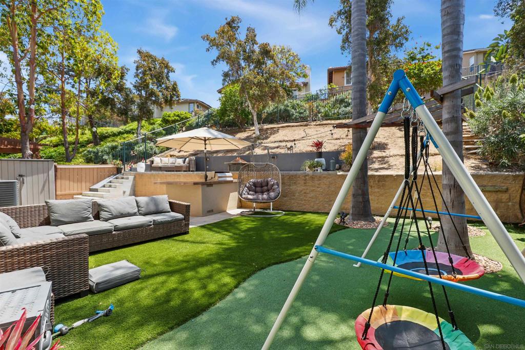 Welcome to this beautifully upgraded 4-bedroom, 2.5-bath home tucked away in a quiet gated Vista neighborhood, ideally located next to a private park with no neighbor on one side—providing enhanced privacy and scenic views of the HOA-maintained greenbelt. Designed with energy efficiency, luxury, and comfort in mind, this home offers true energy independence with an owned 16-panel solar system and a 48kWh LG backup battery. Enter to gaze upon an open-concept layout that seamlessly connects the living, dining, and kitchen areas, creating a bright and inviting atmosphere perfect for both everyday living and entertaining. The kitchen is equipped with granite countertops, brand-new stainless steel appliances, and elegant plantation shutters. Throughout the home, you’ll find upgraded lighting fixtures that add warmth and sophistication. The expansive backyard retreat has been completely reimagined with over $85,000 in renovations, featuring new pavers, low-maintenance artificial turf, a built-in BBQ, a 4-hole putting green, a 39" retaining wall, and an elevated seating terrace—all crafted to maximize outdoor living and capture the peaceful surroundings. The space also includes an in-ground sprinkler system for the side and rear yards and is just a short walk to the community pool, making it ideal for entertaining or relaxing in style. The spacious primary suite provides a serene escape, boasting a spa-inspired bathroom and a generous walk-in closet. Upstairs, you’ll also find a convenient laundry room, adding practicality to the thoughtful layout. Eco-conscious enhancements extend throughout the home, including a newer central A/C unit (2023), a whole-house water filtration system, and an under-sink alkaline drinking water filter. Additional premium features include a whole-house central vacuum, epoxy-coated garage floors, and a new in-sink garbage disposal, rounding out the long list of upgrades that make this home truly turn-key. Blending smart living with comfort and high-end style, this property delivers the perfect balance of privacy, convenience, and sustainability—an exceptional opportunity for today’s modern homeowner.