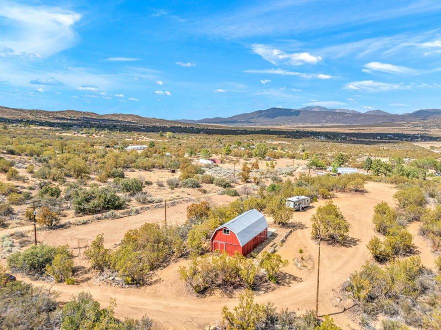 Bring your vision to life on nearly 10 acres in serene Anza. This build-ready property offers true utility and flexibility: a barn served by 200-amp power with dedicated 30-amp and 50-amp RV outlets, a private well, ample RV parking, and a flat, graded homesite to position your future residence. A cut-in driveway is already in place, streamlining access for contractors and equipment.