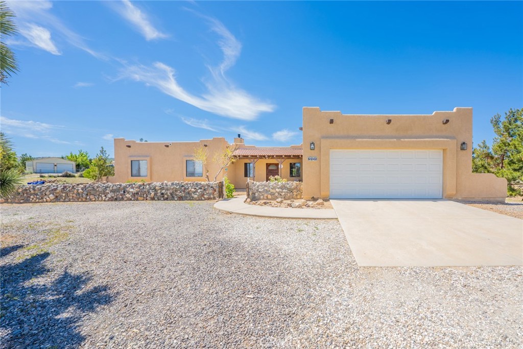 TWO HOMES ON A 4.32 ACRE LOT WITH A BEAUTIFUL VIEW! The main custom built Ranch style home is 2054 Square feet, 3 bedrooms-2.5 bathrooms. The second home (manufactured) is 1272 square feet 3 bedrooms-2 baths and large detached garage. The main home is has tile flooring, large open kitchen, indoor laundry, large master bathroom with separate Jacuzzi type tub and shower, dual sinks. The master bedroom has a private patio to enjoy your morning coffee. The home also offers formal dining area and large family room, living room and front porch with custom built rock wall and landscaping. The second home has open floor plan, fireplace, large master bedroom and bathroom with separate tub and shower. Kitchen is open to dining area and family room. There is also an attached carport and separate Garage! The property is fenced and cross fenced, beautiful landscaping with mature trees. Don't miss this one!