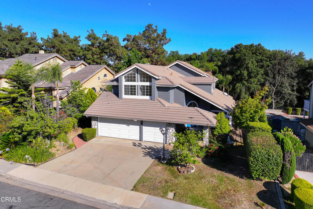 Perched on a tranquil hillside in a quiet neighborhood, this beautifully updated two-story home offers the perfect blend of comfort and space. Freshly painted inside and out, it welcomes you with a marble entry and a graceful curved staircase leading to the expansive primary suite. This retreat features soaring ceilings, large windows that flood the space with natural light, a spacious bathroom with celestial windows, and a generous semi-covered patio for relaxing mornings or sunset views. The second floor offers three additional bedrooms and a full bath, providing ample space for family or guests. Downstairs, you'll find a convenient bedroom and full bath, alongside a laundry area that leads to a spacious three-car garage. The bright kitchen and breakfast nook, bathed in natural light from large windows and a skylight, open seamlessly to the family room, where sliding doors lead to a low-maintenance yard. A newly refreshed pergola is ready to welcome climbing bougainvillea, creating a perfect spot for outdoor gatherings. Located just minutes from restaurants, shops, and the 10 FWY, this home offers both convenience and serenity. Nestled within the highly acclaimed Walnut Valley School District, consistently ranked in the top 1-2% in the nation, this property is an ideal place to call home.