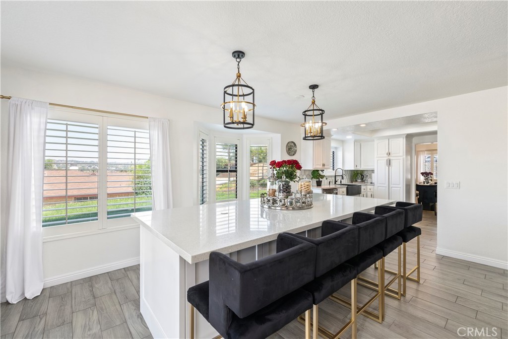 Sweeping 180° views of Big Bear, Mount Baldy, and glittering city lights set the stage for this remarkable corner-lot home in the sought-after Canyon Ridge Estates. Perfectly positioned on a quiet street with no rear neighbors blocking your view and no HOA, it offers both privacy and a daily backdrop of breathtaking scenery. Step inside to soaring cathedral ceilings, sun-filled open-concept living spaces, and timeless plantation shutters that add a refined touch throughout. The gourmet kitchen is a true centerpiece—featuring a striking 10-foot island, custom cabinetry, premium finishes, and seamless flow to the dining and living areas, making it ideal for both intimate gatherings and larger celebrations. The oversized primary suite is a private retreat with corner windows, an en-suite bath, and direct balcony access to enjoy sunsets, starry skies, and panoramic mountain vistas. Two additional bedrooms provide flexibility for family, guests, or a home office. Set on an expansive 13,900-sq-ft lot, this home blends curb appeal and functionality with endless outdoor potential—expand the patio, add a built-in BBQ, create a lush garden, or explore adding one or more ADUs for extended living or rental income.
Hosting is effortless with an extended driveway for multiple vehicles, dedicated RV parking, and a spacious 3-car garage with a built-in private office. Additional upgrades include a whole-house water filtration system and a newer water heater. Financially appealing with low taxes and no Mello-Roos, and ideally located minutes from award-winning schools, parks, shopping, dining, and the 91 and 215 freeways, this home offers an unmatched combination of spectacular views, refined living, and everyday convenience.