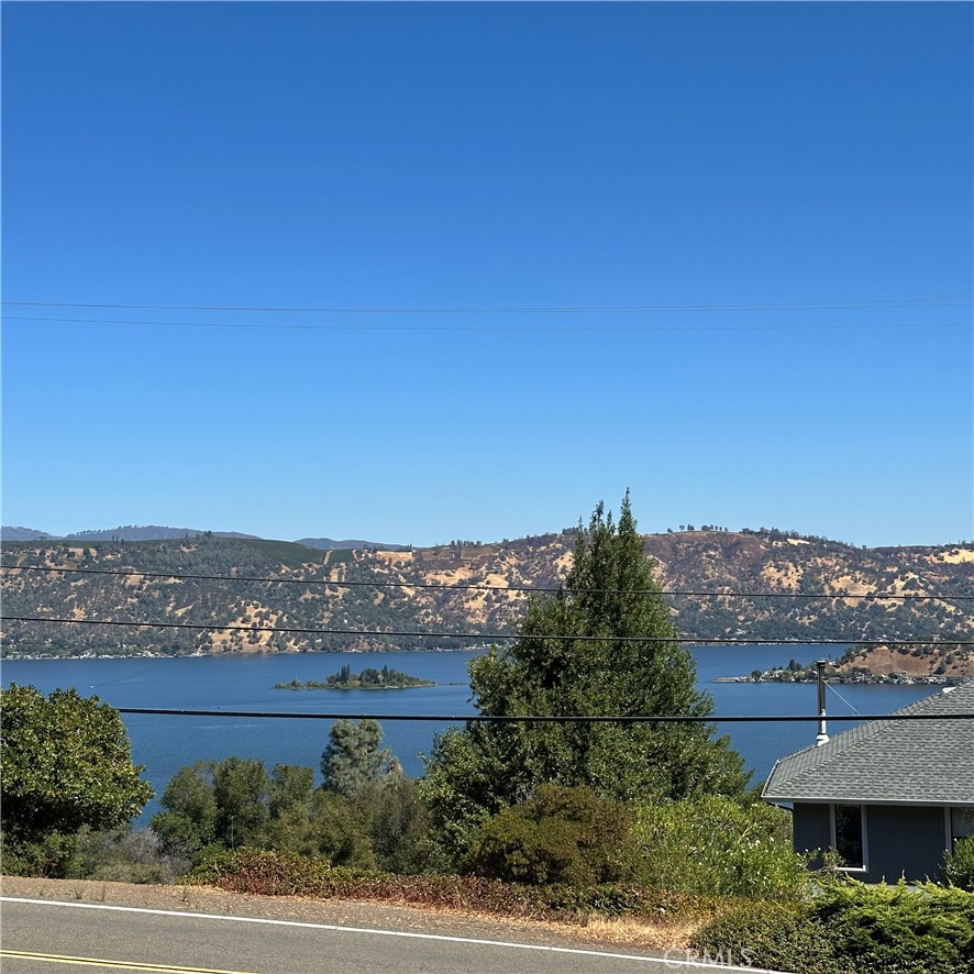 This vacant lot is perched on a gentle incline , offering a breathtaking view of Clear Lake’s shimmering waters. The vastness of the lake stretches out before you, with rolling hills and mountainous ridges providing a dramatic backdrop. The quiet, peaceful environment makes this a prime spot for building your dream home or a quiet getaway.
The views are magical—in the morning, the calm lake reflects a soft sunrise, and in the evening, the sky ignites with rich purples, pinks, and oranges as the sun dips behind the hills. The nearby Clear Lake State Park offers hiking trails, bird watching, and access to the natural beauty of the region.
The lot itself is spacious, offering plenty of room to design a custom home with large windows and expansive decks to maximize the view. Whether you envision a contemporary lakeside retreat or a more rustic cabin vibe, the lot can accommodate it. Plus, the surrounding area is perfect for outdoor activities like boating, fishing, hiking, and wine tasting at local vineyards, giving you the best of both worlds: relaxation and adventure. This is an easy build.