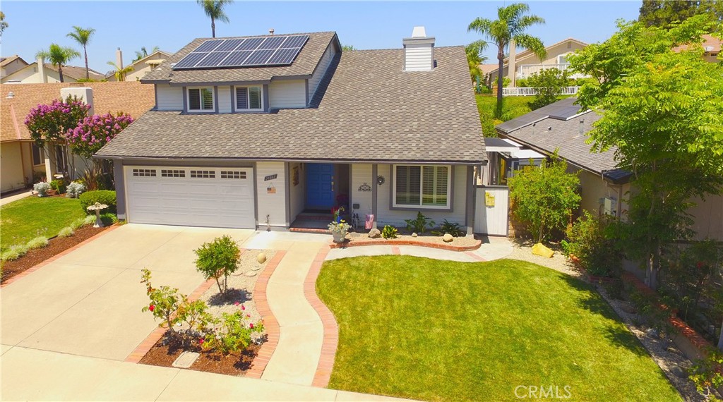 Experience a true Mission Viejo treasure. Highly upgraded Montiel home with fully-owned solar and Lake Mission Viejo amenities. The bright and cheerful entry welcomes you to a beautiful living room highlighted by a romantic fireplace. Four spacious bedrooms and two-and-a-half baths in approximately 1996 sqft. Fabulous kitchen with granite counters, commercial grade Viking stove & refrigerator, Bosch dishwasher, and pleasant breakfast bar. The kitchen is open to a warm and inviting family room. Sunny dining room includes a built-in Sub-Zero wine captain with dual temperature control for reds and whites, Classy bamboo flooring, recessed lighting in all bedrooms, and an attic exhaust fan, Cleverly designed additional storage under the stairs, in the primary bedroom, and in a secondary bedroom. The home was recently re-piped and has a 50 gallon hot water heater with recirculation pump. You will love the amazing, large, private back yard retreat including a spacious patio, multiple seating areas, 13 mature fruit trees, 2 grape vines, and raised flower beds with roses, all on a drip watering system. Plus there is an added greenhouse/potting shed, and a storage shed. An HOA maintained greenbelt at the rear of the property adds to the privacy and serenity of the back yard. Beautiful Crucero Park is just around the corner. Lake Mission Viejo and Oso Creek Golf Course are just down the road. Additionally, very nearby are extensive shopping, dining, Marguerite Recreation Center, YMCA, and Nadadores swim facility. Outstanding Saddleback Valley Unified schools. Low property tax rate and no Mello-Roos assessment. This home can be your forever paradise . . .welcome home !!!