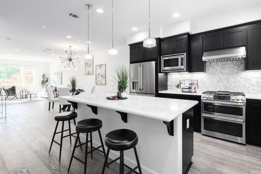 ENJOY DOWNTOWN PROXIMITY IN A WALK-UP SETTING | Built in 2017, this light-filled Sandalwood townhome showcases a prime walk-up location with the privacy of mature foliage only a mile away from downtown shopping and dining! Exquisitely maintained interiors reveal high ceilings, designer lighting, luxury floors, smart climate control, tankless hot water, and zoned AC. Open-concept gathering spaces wired for wall media unfold from a master chefs kitchen fitted with a grand island, elegant quartz countertops, Shaker cabinetry, walk-in pantry, and refrigerator and double-oven range by Cafe, All bedrooms are ensuite, including ground-level guest quarters/office and a primary retreat with dual vanities, a walk-in shower, and dual custom closets. Also enjoy fiber and Cat5E in every room, convenient upper laundry with smart LG appliances, and oversized two-car garage with finished walls and epoxy floors. Community amenities include luxuriant landscaping, private walking paths, a playground, clubhouse, and dog park. Steps from Apple and Google shuttles, and near Downtown Sunnyvale attractions like nightlife, Caltrain, the Farmers' Market, and more!