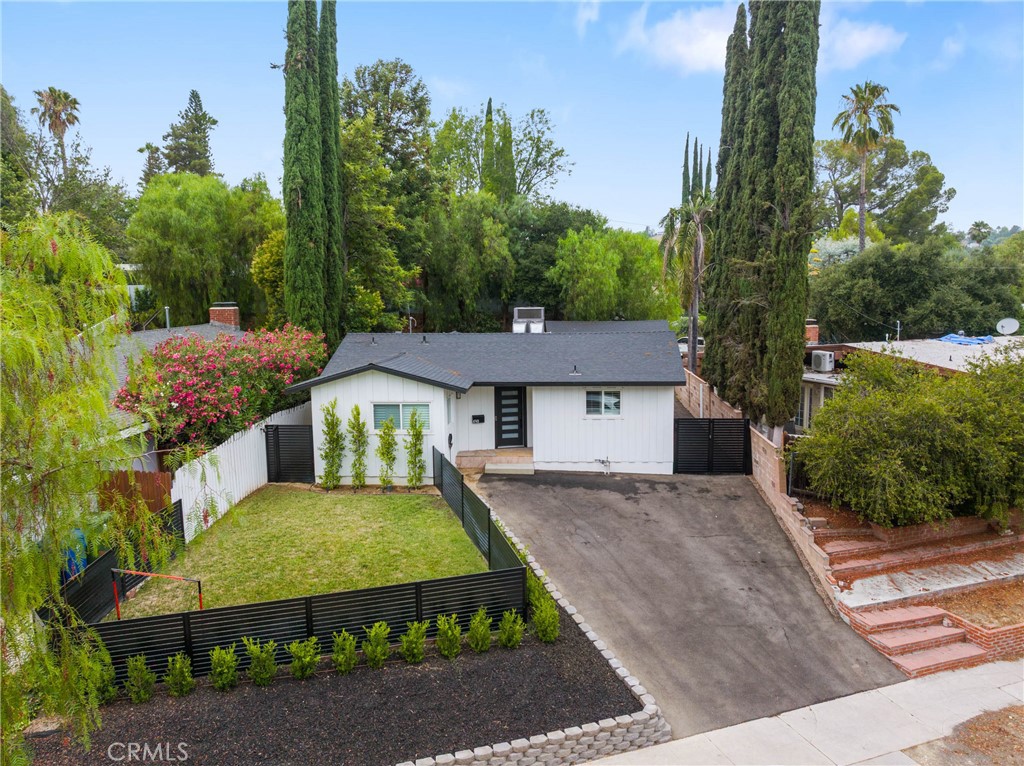 Welcome to this beautifully renovated modern farmhouse in the heart of Woodland Hills.
This single-story, three-bedroom, two-bathroom home effortlessly blends charm with contemporary upgrades, making it a perfect fit for today’s lifestyle. Step into the expansive great room featuring a stunning open-concept kitchen with waterfall quartz countertops, stainless steel appliances, and ample cabinetry—ideal for entertaining or everyday living. Enjoy a spacious family room and dining area with stylish laminate flooring that flows throughout the home. The generously sized primary suite offers comfort and privacy, complete with a designer-finished en-suite bathroom. Step outside to a large, private backyard—perfect for relaxing, entertaining, or enjoying the Southern California sun. The two-car garage provides plenty of storage and offers excellent potential to convert into an ADU (Accessory Dwelling Unit) for added value or income. Two generously sized secondary bedrooms, one of them has been converted into an office. This move-in ready gem won’t last—come see it for yourself!