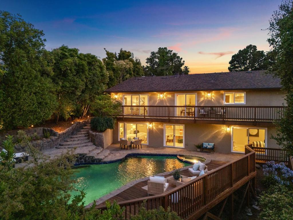 Sunrise Views Over a Backyard Wonderland. In this friendly pocket of San Mateo's Laurelwood neighborhood, 1647 Overland surprises with her understated, manicured street presence and rather serious front door that when open, reveals a home spilling over with warmth and fun. Living spaces are open and comfortable and a remarkable family room/kitchen organizes daily and entertains easily with its flow to the deck and backyard. Four large bedrooms on one level include a private primary suite and one currently finished as a home office. The home's high ceilings, natural flow between spacious rooms, generous closets and storage, and attached two-car garage were designed for modern functionality, while extensive, high quality remodeling and systems upgrades over the years add a happy hum of efficiency. Solar, upgraded electrical / 200 AMP panel, HVAC, roof, drainage, insulation, security system - everything just works, leaving plenty of time to enjoy the peaceful views and private, sheltered backyard wonderland with its waterfall pool and spa. The central location connects for both work and play. Parks, hiking, shopping and restaurants are nearby. Known for its wide, quiet streets, Laurelwood's flexible location near the 92 makes SFO, SF and Silicon Valley easily accessible.