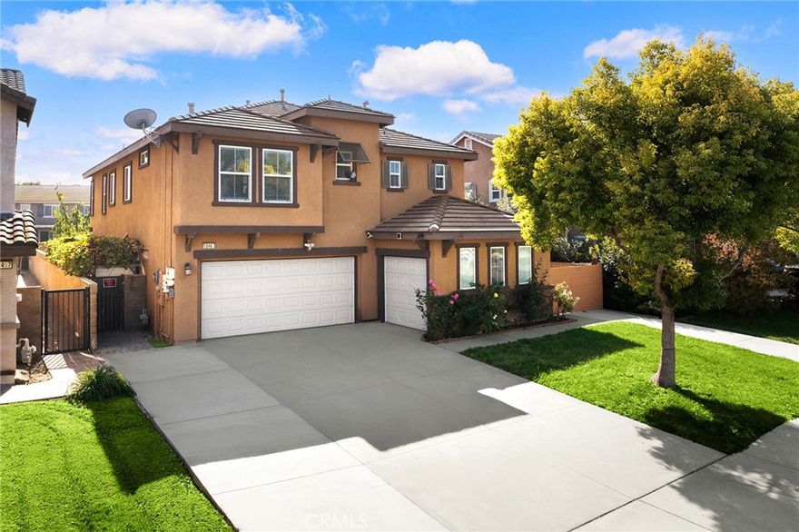 Welcome to this inviting Eastvale residence in the sought-after Harmony Park community. Offering 5 bedrooms and 4 bathrooms across approx. 2,817 sq.ft. on a 7,841 sq.ft. lot, the home features dark hardwood flooring on the main level, a bright formal dining area, and a comfortable family room with fireplace that opens to the backyard. A standout convenience is the main-level suite with kitchenette, washer/dryer hookups, and an independent front-yard entrance—ideal for guests, multi-gen living, or rental (buyer to verify use/permits). The kitchen centers around an granite island with abundant cabinetry. Upstairs showcases new wood flooring, well-proportioned bedrooms, and a welcoming primary suite. Notable upgrades include an energy-efficient A/C system, upgraded water heater, and a solar array totaling 20 panels. Enjoy an enclosed front yard and landscaped backyard for everyday outdoor living. Prime convenience—about 5 minutes to Costco, restaurants, and major shopping, and close to parks and schools.