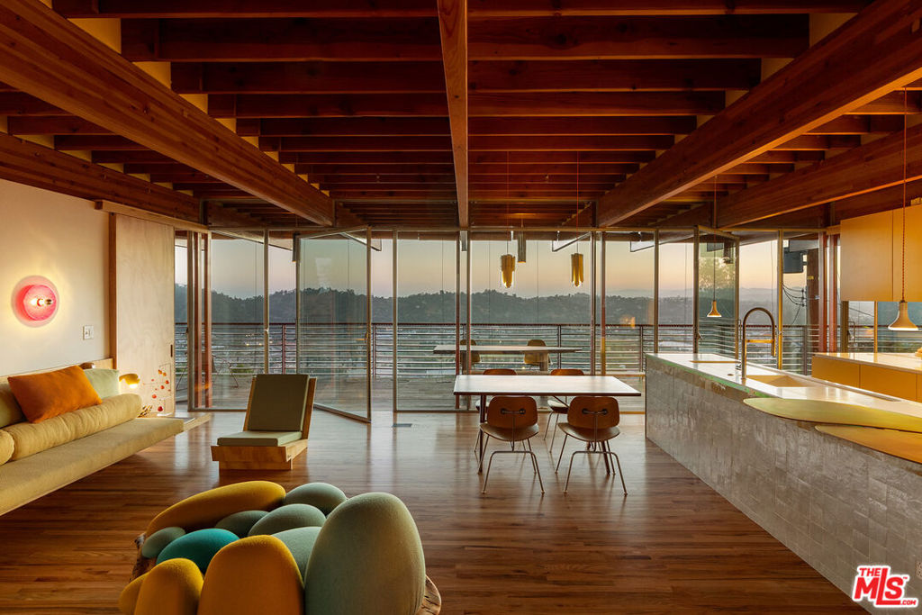 First offering: The Cano Residence, designed by Diego Cano-Lasso, is a true labor of passion. This impressive example of modern architecture captures the essence of Southern California's design ethos. Set in the scenic southwest hills of Mount Washington, the home features stunning city views that are integral to its identity. The striking wooden beams float above the Elysian Valley, while the glass-enclosed interior creates an intact connection with the outdoors. The beams extend outward, framing expansive vistas and leading to a tranquil garden that serves as a private sanctuary. Here, you can enjoy panoramas from the living area while being surrounded by nature. The spacious, sunlit room seamlessly flows into the dining area and large, open-concept kitchen, all of which highlight stunning twilight sunsets. The upper level features a wrap-around terrace with built-in bench seating. Imported Moroccan zellige tile has been expertly hand-laid to reveal one-of-a-kind, imaginative patterns. The home is adorned with red oak flooring and radiata pine throughout, adding to its alluring atmosphere. Bespoke hand-built furniture adds to the playful design, promoting comfort and creativity. Surrounded by vibrant flowers, hawks, hummingbirds, and the soothing sound of a trickling fountain, this space embodies the essence of home. Photography courtesy of Cameron Carothers. Long-Term, Furnished Lease.