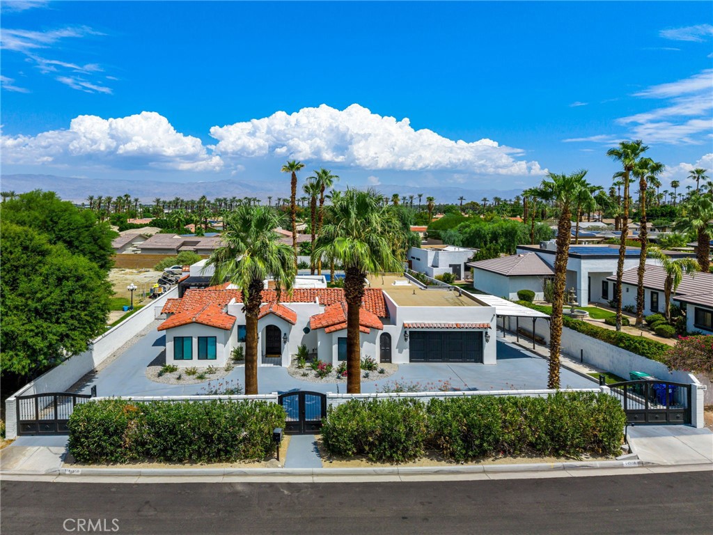 Welcome to Your Private Palm Desert Hacienda Retreat! Discover this one-of-a-kind, gated resort-style estate nestled just blocks from the world-renowned El Paseo shopping district. Originally built in 1949 for famed actress Mrs. Mabley—also known as Ma Kettle—this historic property blends timeless charm with modern luxury across a sprawling 19,000+ sq ft lot. Main Residence Highlights include: Over 3,400 sq ft of living space, 4 spacious bedrooms & 3.5 bathrooms, grand living room with dramatic wood-beamed ceilings and a floor-to-ceiling fireplace, gourmet kitchen featuring brand-new custom cabinetry, granite countertops, oversized island, and top-of-the-line Viking appliances, elegant family room with hardwood floors and expansive multi-slide glass doors opening to the entertainer’s backyard. The Primary Suite offers vaulted ceilings, a spa-inspired bathroom with dual shower heads with luxurious finishes and a private gym for your wellness needs. The two detached Casitas are ideal for guests or multi-generational living, each with its own covered patio perfect for al fresco dining. The outdoor oasis has a sparkling pebble tec pool and spa, pickleball court for active fun, outdoor bathroom and shower, built-in BBQ station for hosting unforgettable gatherings, and breathtaking mountain views that offer peace and privacy. Whether you're seeking a serene sanctuary or a vibrant venue for entertaining, this estate offers endless possibilities to personalize and elevate your lifestyle. Properties of this caliber and character rarely come to market—don’t miss your chance to own a piece of Palm Desert history.