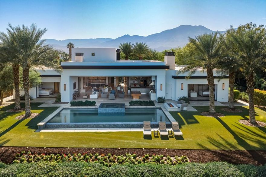 Classic modern architecture meets comfort and style in this 6,985 sq ft home, featuring 6 bedrooms and 6.5 baths, with an open and inviting floor plan that seamlessly blends indoor and outdoor living spaces through expansive pocketing doors. Situated on an interior lot with only one neighbor, this home is ideally situated above the esteemed 1st green of the Tom Fazio Course. This home is offered furnished per inventory. Experience the perfect blend of luxury and tranquility in this exceptional property.