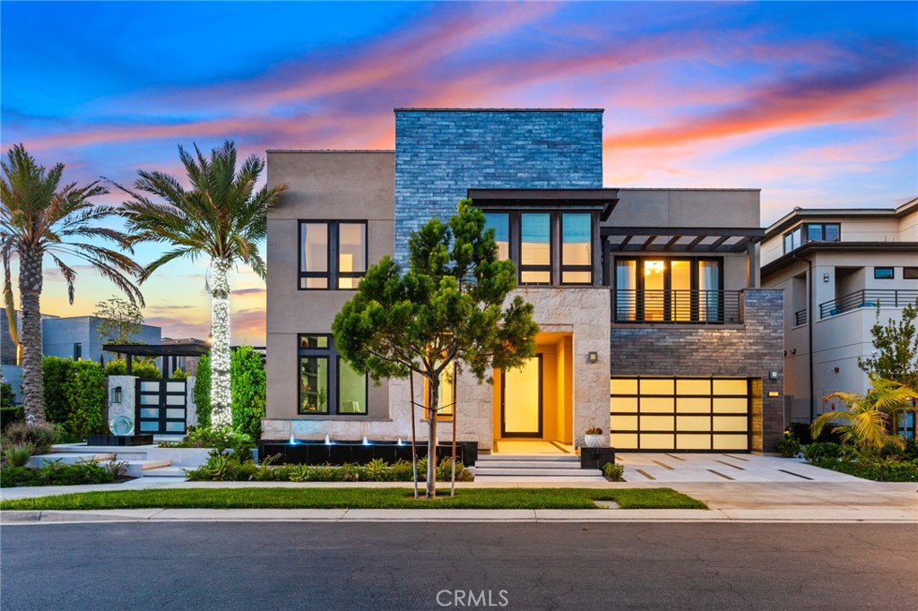 Please discover modern luxury in the prestigious, guard-gated Altair Irvine community with this Toll Brothers Alara—Elite: an exquisite corner home. Thoughtfully designed over three stories and spanning more than 5,000 sqft of living space, every detail has been carefully curated for style, comfort, and entertainment.
Step inside and you’ll immediately notice the extra-tall ceilings, a showy chandelier, and big floor-to-ceiling windows that flood the entry with light. To your left is a roomy home office, then a private guest suite with its own living area, full bath, and wet bar—great for extended family stays or as a quiet work spot.
The main living room is a showstopper, anchored by extra-tall, floor-to-ceiling windows that flood the space with natural light and create a wonderfully airy, bright atmosphere. Sleek, continuous tile flooring runs seamlessly from the entry through the living area into the kitchen. This open-concept kitchen now features two generous quartz-topped islands—perfect for prep, casual dining, or cocktail hour—and the original walk-in pantry has been thoughtfully transformed into a fully equipped wok kitchen with high-end appliances for serious cooking or entertaining.
Head up the glass staircase to find the main suite: a spa-style bathroom, two walk-in closets, and a private balcony where you can relax and enjoy the view. Three more bedrooms each have their own updated bath. Upstairs on the third floor, a large loft with a half-bath and covered terrace makes for perfect movie nights, a playroom, or sunset drinks.
Outside feels like your own backyard resort. You’ve got an infinity-edge pool, hot tub, mini-golf practice green, and a pretty pergola set in a low-maintenance yard with a water feature. An outdoor kitchen with a high-end BBQ station makes grilling and dining al fresco a breeze.
Living in Altair Irvine means you also get access to resort-style pools, a clubhouse, tennis courts, and green parks. You’re just minutes from the Irvine Spectrum Center, Great Park, and top-rated Irvine Unified schools—exactly what modern Irvine life should be.