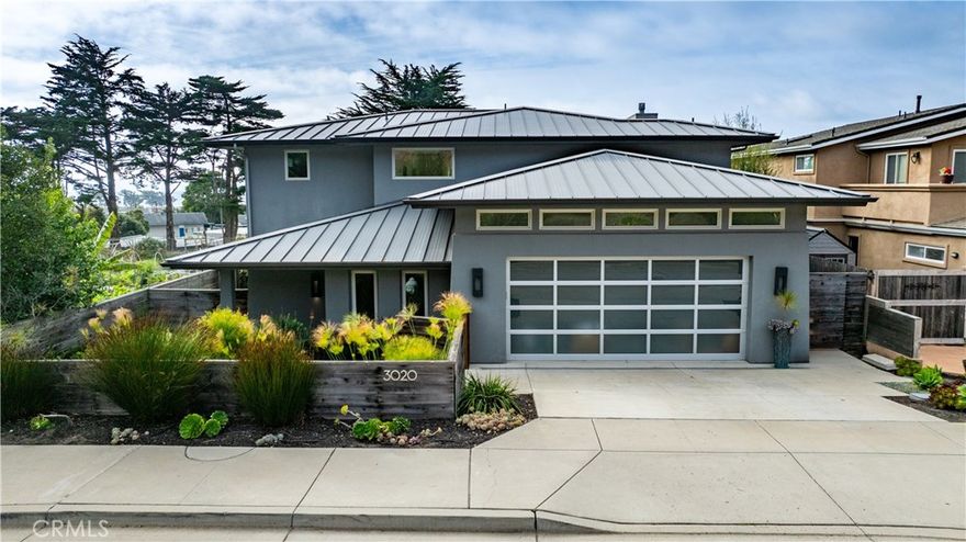 Once in a lifetime opportunity awaits!!  
Welcome home to your Morro Bay coastal retreat! This impressive two-story home seamlessly blends modern features with elevated designs, where you can relax to savor the coastal sunsets and enjoy the charming Del Mar neighborhood. Nestled next to the Estero Bay Community Garden and Del Mark Park, outdoor recreation surrounds you yet the home feels private and serene. With beautifully upgraded interiors enhancing every space, rooms are thoughtfully designed, ensuring comfort and privacy. Tall ceilings and numerous windows let in lots of natural light and breathtaking views are showcased from nearly every room. Enjoy custom features from wide tile floors to stylish light fixtures to integrated media and technologies. Through the main entrance, an custom walnut wood staircase leads to the upstairs open living and dining areas where you'll find a beautiful fireplace and floor-to-ceiling windows, opening to the west-facing deck, perfect for outdoor dining and entertaining. The gourmet kitchen is equipped with high-end appliances, sleek countertops, artistic add-ons, abundant storage, and a spacious pantry while the upstairs en-suite bedroom could be used for a convenient den, office, or play area, overlooking the community garden with special views of the Pacific Ocean and Morro Rock, with its own spacious bathroom and custom walk-in closet. On the main level, the primary bedroom suite is a true sanctuary, complete with calming fireplace, private patio that leads to the back yard and outdoor jacuzzi veranda, plus a gorgeous en-suite bathroom complete with soaker tub, expansive double sink vanity, large walk-in shower, built-in cabinetry, and an extra-large custom closet. Two additional roomy bedrooms offer south-facing windows and custom closets with both a shared full bathroom and laundry room off the hallway that lead to outdoor spaces. Surrounding the home, enjoy meticulously landscaped outdoor living areas and an outdoor shower. The double garage offers plenty of space for vehicles and storage. Don't miss your chance to own this extraordinary home in beautiful Morro Bay along the Pacific Coast Highway, conveniently located just a few minutes to downtown shopping and restaurants, stunning beaches, and the numerous activities throughout San Luis Obispo County.