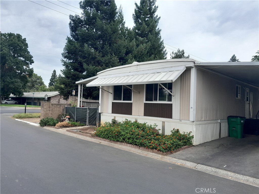 Wait until you see this one! Ready to move in and enjoy the private garden oasis. There are very few Homes that boast 2 side yards and a Woodstove in the Living Room. This 2 Bedroom, 2 Bath home has new flooring and new Roof. Open Kitchen leads to the dIning area. There is extra square footage that can be used in the covered porch outside of the Bedroom slider. Covered Carport has enough room to fit 3 modest cars in the driveway. Surrounded by mature landscaping you will so much shade and privacy. There are 2 sheds on the property, one of them has electricity. Central Heating and Air Conditioning. View this one today!