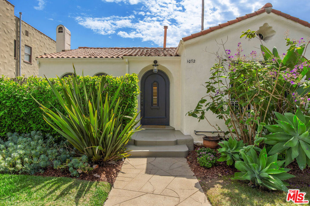 Found within the coveted Carthay Square Historic Preservation Overlay Zone, 1072 Hi Point is a beautifully renovated Spanish Colonial Revival home that captures the heart from the moment you step through the door. This enchanting 2-bedroom, 1-bathroom residence seamlessly blends original architectural details such as the Batchelder style fireplace with modern functionality, offering an immediate sense of warmth and belonging. Meticulously maintained over the years, the home features an updated kitchen and bathroom that cater to contemporary living while preserving the timeless charm of the property. The thoughtful renovations ensure that every corner of this home is not only aesthetically pleasing but also perfectly practical. Cap it off with a large rear yard perfect for entertaining, gardening, playing and relaxing. Beyond its captivating allure, the location is truly second to none. Enjoy the convenience of being within walking distance to places of worship and highly desirable schools. Immerse yourself in the vibrant culture of the neighborhood, with The Grove, LACMA, Museum Row, and an array of shopping and dining options just a short distance away. Furthermore, with the new Metro Purple Line station at Fairfax and Wilshire just a few blocks away, future commutes and city exploration will be effortlessly accessible. 1072 Hi Point is more than just a house; it's a beautifully preserved piece of history offering a modern, comfortable lifestyle in one of Los Angeles' most desirable and well-connected neighborhoods. This is an opportunity to own a home where every detail has been cared for, and every day feels like a new beginning.
