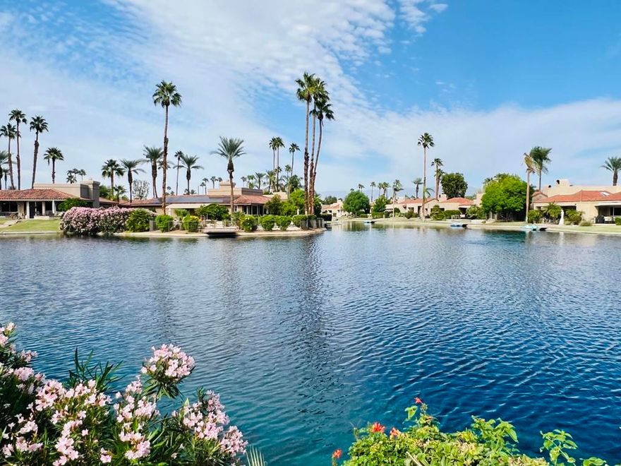 Nestled within the heart of Lake Mirage, this beautifully updated 3-bedroom, 3-bath residence combines comfort, elegance, and resort-style living. Step inside to a light-filled, open floor plan featuring tile and wood-look flooring throughout, classic wood shutters, and soaring cathedral ceilings. A double-sided fireplace warms both the living and dining areas, creating an inviting atmosphere for relaxing or entertaining. Expansive windows frame panoramic views of the lake and surrounding mountains, while the spacious patio invites you to enjoy tranquil mornings or sunset gatherings by the water. The primary suite offers peaceful lake views, a generous walk-in closet, and a luxurious ensuite bath complete with jetted tub and separate shower. Each bedroom features direct access to its own bathroom, ensuring privacy and convenience for all. This highly desired floor plan offers the ease of single-level living--no interior steps--and includes an assigned dock, perfect for a small electric boat or kayak. Located within the prestigious Lake Mirage Racquet Club, residents enjoy world-class amenities including 25 acres of open lake for sailing and rowing, scenic jogging and cycling paths, 10 tennis courts, 2 pickleball courts, 11 pools and spas, a fitness center, and a clubhouse ideal for private gatherings. All set within a guard-gated community just minutes from premier shopping, fine dining, and top-rated healthcare in the heart of Rancho Mirage.
