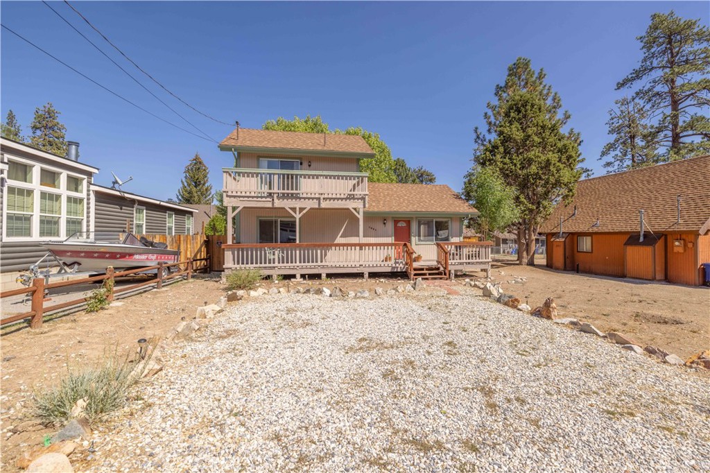 This charming 2 bed, 2 bath home is light and bright with high ceilings, open floor plan, breakfast bar, a main floor bedroom with inside laundry, and a fully fenced backyard with a storage shed! This beautiful home has both front and back decks on the main level as well as an upper deck off the primary bedroom to enjoy the fresh mountain air and gorgeous views of nearby Gold Mountain! This home is turnkey and ready to go! Centrally located in Big Bear City just off of North Shore it is close to hiking, biking, off roading, Big Bear Mountain Resorts, The Village, and of course beautiful Big Bear Lake! This property could be a great starter home, vacation home, or rental property either short or long term. Just in time for the holidays and upcoming winter season you won't want to miss on out this wonderful opportunity to own your personal slice of paradise here in beautiful Big Bear!