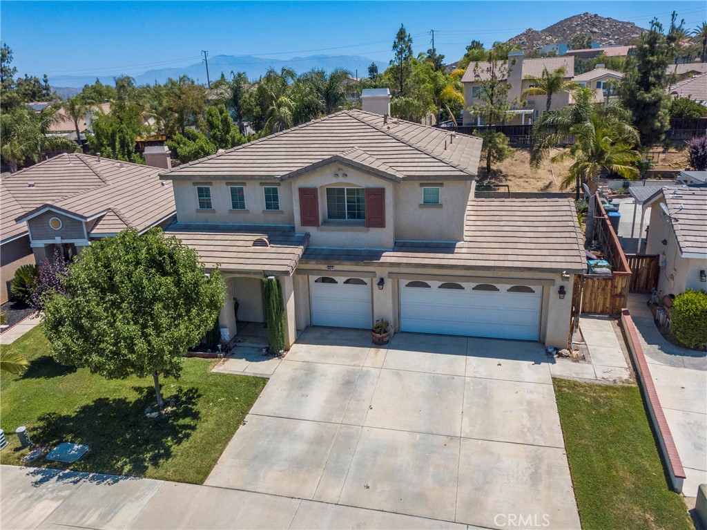 Pride of ownership shines throughout this beautifully upgraded home located on a peaceful cul-de-sac in the highly sought-after Moreno Valley Ranch community. Boasting 4 bedrooms and 3 bathrooms across 2,572 sq ft, this spacious layout includes a main floor bedroom and full bath, perfect for guests or multigenerational living. The open-concept living area features a cozy tile fireplace, tile and laminate flooring, and plenty of natural light. The kitchen offers ample storage, generous counter space, and flows seamlessly into the main living areas—ideal for both everyday comfort and entertaining. Upstairs, you’ll find a versatile loft perfect for a home office, playroom, or second living space, along with an expansive primary suite featuring dual walk-in closets, a retreat area, and a spa-style bathroom with a soaking tub and separate shower. Outside, the large backyard is your private escape—complete with a durable Alumawood patio cover, newer AC unit, mature landscaping, and plenty of space for relaxing or entertaining. A spacious three-car garage offers excellent storage and functionality. Set within a top-rated school district and just minutes from shopping, dining, and Moreno Valley College, this home is perfect for growing families seeking space, comfort, and community. Residents also enjoy access to Moreno Valley Ranch’s resort-style amenities—including a private lake, clubhouse, pool and spa, fitness center, playgrounds, and scenic walking trails.