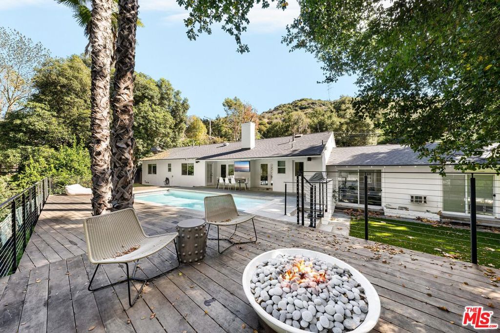 Behold this magnificent oasis at 3443 Mandeville Canyon Rd, Los Angeles! This immaculately renovated three-bedroom, three-bath home is situated on an expansive 24,540 square foot lot. Step into your own private paradise, where the tranquil ambiance is serenaded by the gentle chirping of birds. Recently added to the home is the sparkling pool in the backyard which beckons you along with its' sprawling green lawns and built-in barbecue area, perfect for hosting gatherings or basking in solitude. You'll enjoy the indoor-outdoor flow and wonderful lay-out of this family home. Discover the joy of leisurely afternoons and boundless entertainment with ample space for trampolines, making it an idyllic retreat for families or anyone seeking peace and privacy amidst nature's embrace. This won't last!