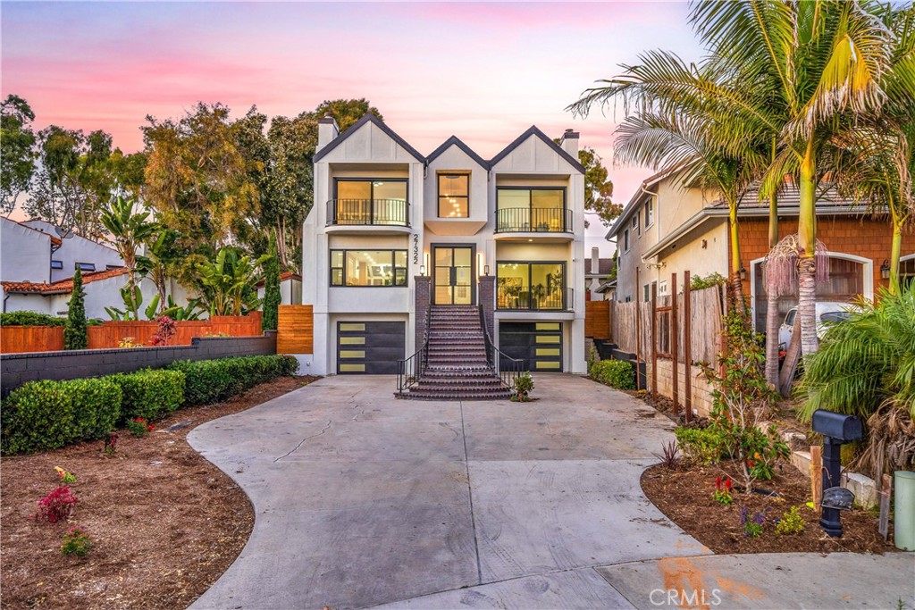 This exceptional, custom-built residence in the heart of Capistrano Beach, presents a rare and unparalleled opportunity for the discerning homeowner. Situated on an expansive 7,200 square foot lot, this magnificent home has undergone a comprehensive and meticulous renovation, extending far beyond a superficial refresh, to deliver a truly exquisite coastal living experience. Upon entering the one is greeted by an atmosphere of refined elegance and breathtaking panoramas. The generously proportioned living and dining rooms seamlessly flow together, inviting entertaining and showcasing the mesmerizing ocean views that are a focal point from nearly every front-facing room. A sophisticated family room with a newly appointed fireplace provides a cozy retreat, while the gourmet, galley-style kitchen and bright eat-in nook also bask in the splendor of the Pacific. Ascending to the upper level reveals a luxurious primary suite, a sanctuary of tranquility complete with its own fireplace. The spa-inspired primary ensuite is a testament to indulgence, featuring dual sinks, an opulent oversized walk-in dual shower and tub complex and a large walk-in closet for effortless organization and style. Two additional well-appointed secondary bedrooms, one of which offers captivating ocean views, share a large bathroom with convenient double sinks. Beyond the walls of this magnificent residence, a life of coastal adventure and leisure awaits. Situated mere moments from pristine beaches, the vibrant Dana Point Harbor, and the iconic San Clemente Pier, this residence offers unparalleled access to a myriad of recreational and cultural experiences. Embrace the opportunity to partake in luxury year-round, with world-class golf courses, exquisite special events, and nearby five-star resorts like The Ritz-Carlton and Waldorf Astoria Monarch Beach Resort further enhancing the desirability of this exceptional location. This home has been thoughtfully reimagined with a discerning eye for detail and the highest quality finishes and masterfully blends resort-style coastal living with a casual beach-inspired ambiance, creating a truly unparalleled lifestyle opportunity. Welcome Home.