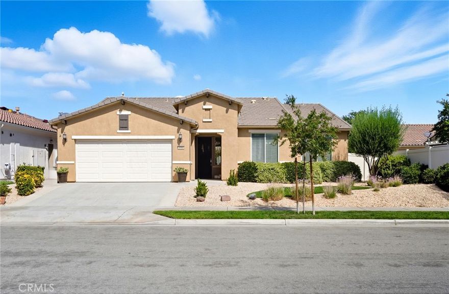 This is it—your turnkey Haven model in one of Southern California’s most sought-after active adult 55+ communities. This spacious single-story offers 3 bedrooms, 2 bathrooms, and 2,030 sq. ft. of well-designed living space, plus one of the largest backyards in the neighborhood.

Inside, you’ll find low-maintenance 20" porcelain (installed on a diagnal) square tile flooring and an inviting open-concept layout. The gourmet kitchen is a showstopper, featuring a massive granite island with sink, walk-in pantry, and premium KitchenAid and Bosch appliances including a sleek stove hood and separate dining area. Entertain with ease thanks to the built-in wet bar with wine rack, sink, wine fridge, and abundant cabinetry. The family room shines with a modern shiplap accent wall, while the primary suite provides its own backyard access and a spa-inspired ensuite with dual sinks, soaking tub, walk-in shower, and large walk in closet with upgraded built in system. Two additional bedrooms and a full bath are located down a seperate hallway and seperated from the primary. The backyard is an entertainer’s dream—complete with a covered patio and ceiling fan, stamped concrete with gas-wired firepit, lush landscaping, and vinyl fencing. Gardeners will love the six cedar planter boxes with drip irrigation, producing fresh vegetables (including green peppers) alongside mature orange and lemon trees on the side yard. Additional upgrades include: Mohawk RevWood engineered flooring in bedrooms, tankless water heater, ADA-friendly doorways, hallways and toilets, recessed LED lighting, ceiling fans in every room, interior sprinkler system, coat closet, new AC condensation pan, new sprinkler valves and extra deep garage for trucks. Living in Solera Diamond Valley means access to the award-winning Mountain View Lodge—23,000 sq. ft. of resort-style amenities. Enjoy a state-of-the-art fitness center, indoor lap pool, spa, walking track, aerobics studio, hobby and craft rooms, ballroom, library, computer station, card room, billiards, and coffee bar. Outdoor amenities include two pools, tennis courts, bocce ball, BBQ areas, and miles of walking trails. Not to mention the monthly "View" Magazine offering residents a calendar of planned social events! Don’t miss this opportunity to own a beautifully upgraded home with one of the community’s best backyards in a vibrant, active setting!