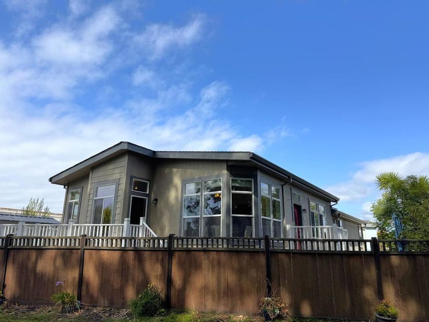 Here it is! It's what so many are waiting for!  A Creekside Drive home overlooking the beautiful green belt and trail that runs along the outer edge of Canada Cove 55+ Mobile Home Park.  The amenities of this home are what makes a great home: a gourmet kitchen complete with prep island with a large sink with so much counter space and cabinets, plus full size pantry and enough room to fit a dinette set.  High ceilings and tall windows bring in all the light to inspire.  A large living room facing east with privacy behind the lushly landscaped front yard.  Two well-sized bedrooms plus a den with a pass-through closet featuring operational windows, that link back to the primary bathroom; a unique flow. The primary bathroom has a stone stall shower, two vanities, and a deep jetted tub.  The primary bedroom features a full size walk-in closet complete with storage system.  Laundry room just off the kitchen with sink and storage closet.  Detached shed with pull-up door and side door, fully lit and insulated - bring the hobbies with you!  Canada Cove is a community where you can thrive: Seasonal saline swimming pool, Bocce ball, exercise room, billiards, game room, reading groups - you name it, they might just have it here!