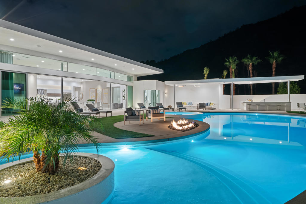 The Best of the Best from Design to Location. This brand-new Contemporary Turnkey Furnished --a sanctuary of sophistication nestled in gated ONE Las Palmas, Curvilinear Design, the architecture itself is a work of art--a testament to modern aesthetics. Enormous Great Room with ceilings soaring beyond 13 feet, and entire multi-slide wall creating seamless harmony from indoors and out. Every detail, from the custom furnishings and lighting to the carefully curated art, speaks of refined taste. All this opens to your outdoor oasis with the free-form pool beckoning. Lounge on the tanning shelf, sip a cocktail by the outdoor fireplace, or practice your putting on the green. Complete Indoor-outdoor Entertainment including a 98'' TV over the pool! Gourmet Kitchen set up for intimate enjoyment or big-time entertainment with oversized island adorned with quartz counters. Top-of-the-line Wolf and Subzero appliances and exquisite cabinetry. Spa-Like Primary Suite with view bedroom, lounging bathroom with two-person shower and an artful bathtub. and direct access to private Zen patio with it's two-person outdoor shower, bathtub and fire feature. Each of the 4 other bedrooms is a designer's canvas and your guests will be pampered. Full Net $0 Solar including batteries and even pool heating. Reverse Osmosis whole house system and much more. Available for immediate enjoyment!