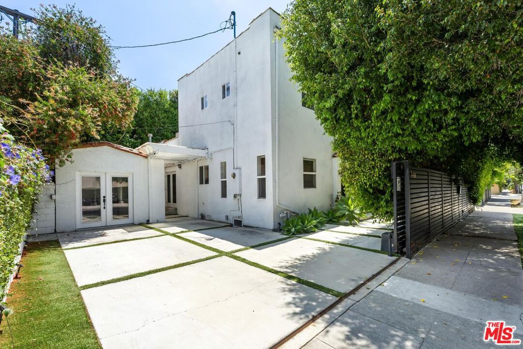 Welcome to 7614 Willoughby Avenue, a gated oasis nestled in the heart of West Hollywood. This private two-story home is secured by an electronic steel gate with Ring intercom, offering peace of mind and convenience. Spanning 1,808 square feet, the residence features three bedrooms and two bathrooms, all with wide plank engineered hardwood floors. The oversized primary suite occupies the entire 2nd level and offers plenty of room for bed + separate seating area or bed + baby nursery. The primary bath boasts dual-head waterfall shower, a luxurious bath, and an expansive walk-in closet. The gourmet kitchen is equipped with top-of-the-line stainless steel appliances, quartz countertops, and a farmhouse sink. Enjoy the spacious living room with an electric fireplace + formal dining with breakfast bar. Downstairs, 2 guest bedrooms both open to private outdoor spaces. The detached garage has been converted into a versatile flex space that can be used as office, along with laundry. Additional amenities include a private outdoor yard and long driveway for parking. Unfurnished and ready for your personal touch, this home is a West Hollywood gem. TERMS: available right away, 12 months, unfurnished, tenant pays utilities, 3-car parking, no garage parking.