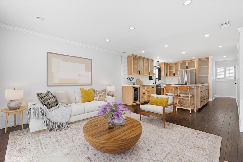 Welcome home to this beautifully updated 2-bedroom, 2.5-bath corner townhome in the heart of West LA, offering 1,180 sq ft of stylish, light-filled living space. Front entry features guest half bathroom, coat closet, and hallway that walks into the open-concept kitchen, living, and dining area. The remodeled chef’s kitchen is a true standout that features custom white oak cabinetry, sleek quartz countertops, and a center island that adds both countertop space and seating for guests. Appliances include a KitchenAid Gas Range/Oven with downward venting, KitchenAid Dishwasher, LG Refrigerator, Samsung Microwave and nice wine fridge - ideal for entertaining and everyday living. The main floor boasts espresso-toned wood flooring and LED recessed lighting throughout. The living room features a gas fireplace and sliding glass doors that open to a spacious private balcony, perfect for BBQ'ing or relaxing. Upstairs, you’ll find two spacious bedrooms with upgraded carpet, mirrored closet doors, plantation shutters, and recessed LED lighting. Both bathrooms have been modernly upgraded with porcelain tile flooring, white ceramic shower tile, and quartz-topped vanities. Enjoy direct access to a private 2-car tandem garage with two large storage areas, a gas water heater, included LG front-loading washer and dryer, and Central A/C unit, controlled by NEST Thermostat. Quiet 8-unit complex with low HOA dues. Unbeatable Westside location - walking distance to many restaurants, lifestyle plazas and just blocks from the vibrant Sawtelle Japantown, close to UCLA, and easy access to the 405 and 10 freeways. Don’t miss this opportunity to own a beautifully upgraded townhome in one of the city’s most desirable neighborhoods that checks all the boxes for comfort, style, and convenience!