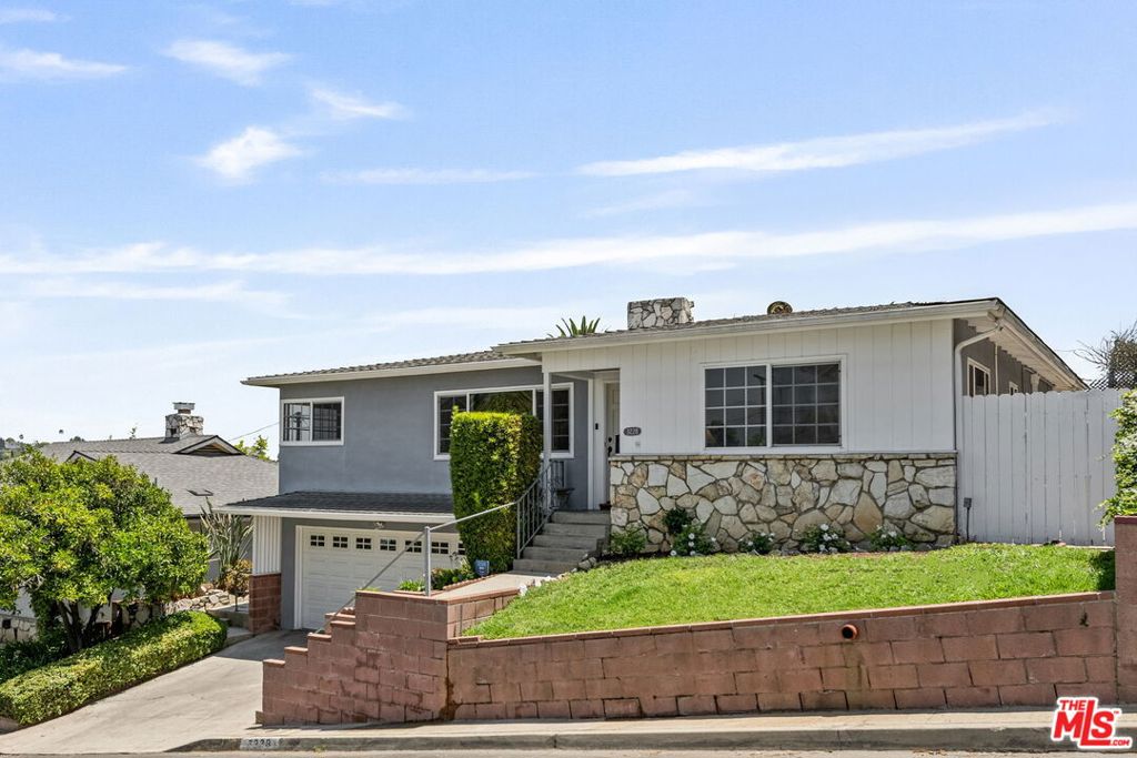 Welcome to 3228 Sagamore Way - a charming 1950s traditional residence nestled in the serene Verdugo Hills of Glassell Park. Owned by the same family for 42 years, this property offers comfort, character, and plenty of potential in one of Northeast LA's most sought-after neighborhoods. This 2-bedroom, 2-bathroom residence features two inviting living areas anchored by a striking Palos Verdes stone fireplace. Whether you're enjoying a quiet evening or gathering with friends, there's ample space to unwind and connect. Original hardwood floors run throughout most of the house, adding warmth and timeless appeal. In both bathrooms, vintage tile adds colorful, nostalgic details that reflect the home's era. The classic kitchen and dining nook include windows that frame peaceful hillside views and fill the interior with natural light throughout the day. Enjoy several outdoor areas perfect for dining, relaxing, and soaking up the hillside views. The above-ground swim spa is ideal for year-round use - cooling off on warm days and perfect for relaxing on cooler evenings. A detached bonus structure offers flexible space ideal for a home office, creative space, or yoga room. Located near local favorites like Little Ripper Coffee, Wife and the Somm, and Lemon Poppy Kitchen, this home combines the quiet beauty of hillside living with the vibrant culture of Glassell Park.