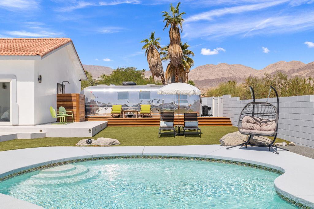 Modern Luxury Meets Desert Charm!Step into elevated living at this fully renovated and beautifully furnished retreat in the coveted Silver Spur Ranch of South Palm Desert. This stylish four-bedroom, three-bathroom home is designed with intention--from premium finishes and top-tier appliances to an expansive chef's kitchen anchored by an oversized island perfect for entertaining.Experience effortless indoor-outdoor living as dramatic sliding glass doors reveal a private backyard oasis with unobstructed mountain and down valley views. The low maintenance landscape with artificial turf keeps this yard not only neat, but stylish. Whether hosting guests or unwinding under the stars, the outdoor space is a showstopper.Adding an unexpected twist, the property features a fully upgraded luxury Airstream--professionally connected to power and sewage--with adjacent outdoor shower, offering a chic guest suite or flexible bonus space.Sustainable and serene, this solar-powered home sits on a quiet cul-de-sac street just minutes from El Paseo's boutique shopping, gourmet dining, and world-class golf. This home blends desert elegance with modern convenience--your Palm Desert dream begins here.