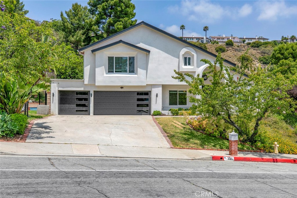 Nestled in the serene and highly coveted Emerald Isle neighborhood of Glendale, this gorgeously remodeled two-story home offers 2,849 sq ft of luxurious living on a beautifully landscaped lot. From the sleek contemporary exterior and 3-car garage to the soaring vaulted ceilings and wide-plank European oak floors, every detail exudes modern elegance. The sun-drenched living and family rooms flow seamlessly into a show-stopping gourmet kitchen featuring a waterfall island, custom cabinetry, quartz countertops, and high-end appliances. Upstairs, spacious bedrooms provide peaceful retreat, while designer bathrooms boast floating vanities, frameless glass showers, and a spa-like soaking tub. Step outside to your private backyard oasis—complete with a sparkling pool, lush greenery, and multiple entertaining spaces. Zoned to top-rated Glendale schools and minutes from The Americana, Whole Foods, parks, and freeway access, this turnkey stunner is the perfect blend of style, space, and location. Welcome to Emerald Isle living at its finest.