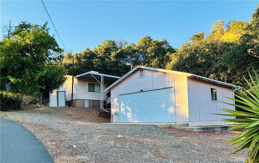 This spacious manufactured home sits on a generous third-acre lot in one of Clearlake Park’s most desirable neighborhoods. The property features a well-built detached garage, a large covered deck with peekaboo views of Clear Lake, and plenty of outdoor space for entertaining or relaxing under the trees.
Inside, you’ll find a bright living room with large windows and a cozy fireplace, along with a huge primary suite complete with a soaking tub and a walk-in closet. The home has great bones and only needs a little TLC to really shine.
The neighborhood offers paved roads, low traffic, and an exclusive community beach for residents of this street only—complete with a boat launch and boat parking. At this price, with so many perks already in place, it’s an excellent opportunity for a weekend getaway, full-time residence, or investment property.