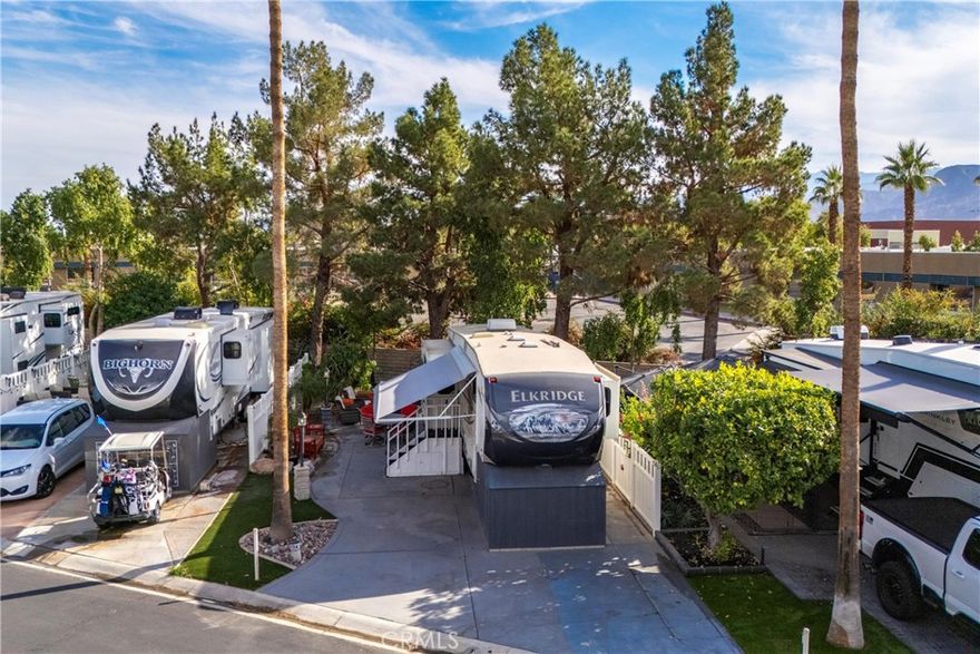 Lowest-Priced Package in Outdoor Resorts Palm Springs RV Resort & Country Club!
Discover a beautiful and highly desirable shaded lot located toward the rear of the resort between Satellites E & F. This upgraded lot offers exceptional usability with expanded concrete surfaces, AstroTurf landscaping, and vinyl fencing for added privacy. A greenbelt maintained by the resort sits directly behind the lot, enhancing both views and outdoor enjoyment.

This package includes all patio furniture and a 2013 Heartland Elkridge Series M-34TSRE fifth wheel featuring:
• Max sleeping capacity of 6
• 3 slide-outs
• 57-gallon fresh water tank
• 80-gallon gray water tank
• 40-gallon black water tank
• 10-gallon water heater
• 14.2-gallon propane capacity
• Newer front dog house and matching stairs

All 1,213 sites within the resort are equipped with metered 50-amp electric, water, and sewer service. Outdoor Resorts Palm Springs spans 137 beautifully landscaped acres and offers an unmatched array of amenities, including:

• 27 holes of executive golf, (fees included in HOA Dues)
• 10 tennis courts
• 13 pickleball courts
• 8 swimming pools
• Dog park with large & small dog areas
• Fully equipped fitness center
• Beauty salon/barbershop
• Full-service restaurant
• Two clubhouses
• And so much more!

Outdoor Resorts Palm Springs is known for exceptional value, a vibrant community, and an experience unlike any other. Call me today to tour and find your slice of paradise!