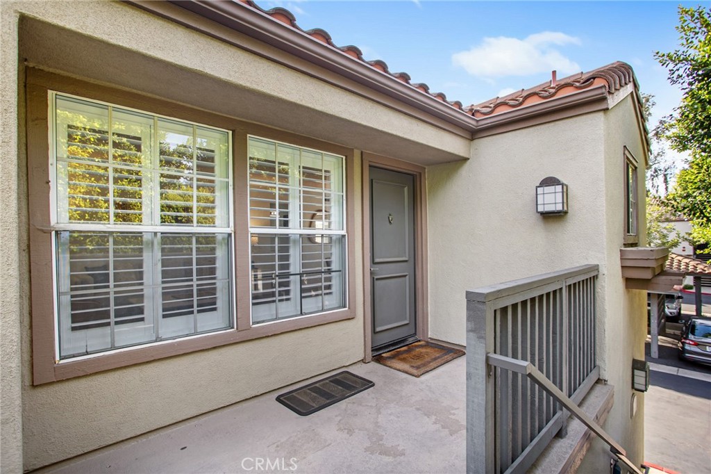 Welcome to 2800 Keller Drive #80, a beautifully upgraded end-unit condo in the sought-after Mandevilla community of Tustin Ranch! This bright and inviting 2-bedroom, 2-bathroom home offers nearly 900 sq. ft. of comfortable living space, all on a single level with no neighbors above or below. Wood flooring runs throughout, adding warmth and style to the interior. The remodeled kitchen features refreshed cabinetry and updated countertops, while both bathrooms have been tastefully upgraded with modern vanities, new countertops, and stylish finishes. The spacious primary suite includes a walk-in closet, a private en-suite bathroom, and access to a private balcony, perfect for morning coffee or evening relaxation. The secondary bedroom also offers its own walk-in closet. Additional conveniences include in-unit laundry, central A/C, and a private 1-car garage with an EV charger hookup, plus an assigned carport for extra parking. Residents of Mandevilla enjoy resort-style amenities including a sparkling pool and spa, fitness center, clubhouse, and playground. With its prime location near Tustin Ranch Golf Club, Tustin Marketplace, award-winning schools, parks, and easy freeway access, this home combines comfort, style, and convenience. Move-in ready and ideally located, this gem won’t last long!