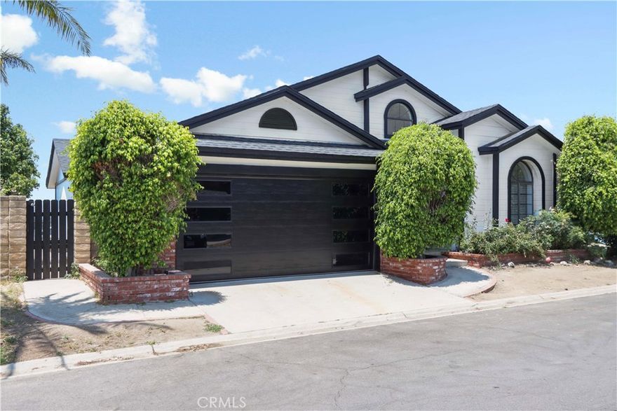 In Santiago Estates, homes are addressed by space number, though each is located on its own named street—this home is situated on the community street known as Via San Diego. Welcome to this newly renovated mountain retreat located in the highly sought-after Santiago Estates community in Sylmar, offering 1,652 sq ft of beautifully upgraded living space. Situated on the scenic side of Lopez Canyon, this 3-bedroom, 2-bathroom home has been completely transformed inside and out. At the heart of the home is a showstopping kitchen featuring a massive waterfall quartz peninsula that seats six or more, a farmhouse kitchen sink, soft-close cabinetry, matching quartz countertops throughout (including hallway shelving), and upgraded stainless steel appliances—all tied together by an open-concept layout perfect for entertaining or everyday living. Adjacent to the kitchen is a spacious den with a gas fireplace, offering a cozy yet flexible space that can be used as a second living area, media room, or formal dining space. A separate living room at the entry provides even more room to spread out or entertain. The expanded primary suite features double sliding glass doors to a private patio, a generous walk-in closet, and a fully remodeled en suite bathroom with a double vanity, freestanding clawfoot tub, and a walk-in shower. Two additional bedrooms and a modernized guest bathroom round out the interior upgrades. The home also includes a new HVAC system, a 2-car garage with a 2-car driveway, and two distinct outdoor areas: a courtyard and a backyard offering panoramic canyon views. Exterior improvements—including new roof, skirting, and fresh paint—are being finalized, and some listing photos may show temporary construction materials. Interior garage photos are coming soon. This turnkey home blends top-tier finishes, spacious design, and scenic surroundings, making it one of the finest offerings in the San Fernando Valley’s premier manufactured home community.