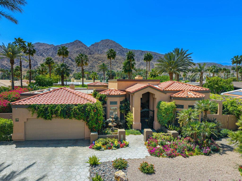Welcome to luxury desert living within the exclusive Indian Wells Country Club. This custom estate invites you in through double leaded-glass doors into a grand entry, boasting soaring ceilings and stone flooring. Crafted for everyday comfort and upscale entertaining, the layout features a formal dining area with built-in buffet and an elegant living room with a cozy fireplace and views of the sparkling saltwater pool. The adjacent family room and gourmet kitchen, complete with porcelain floors, quartz countertops, and a seating nook, ideal for casual gatherings. The well designed floor plan offers privacy with two separate wings. The primary suite is your own private retreat, featuring a fireplace, office alcove, and bath with jacuzzi tub, walk-in shower, dual vanities, and a large walk-in closet. A second ensuite bedroom and powder room complete this wing. Across the home, two additional ensuite bedrooms provide the perfect setup for guests. Step into the backyard oasis, where multiple outdoor living spaces await. Dine under the covered patio with a built-in outdoor kitchen, lounge in the gazebo, or soak up the sun on the deck. Surrounded by lush landscaping, the saltwater pool and spa offer the perfect escape from warm desert days. Additional highlights include an epoxy garage with storage and golf cart parking. All with NO HOA! Call to schedule your private tour!