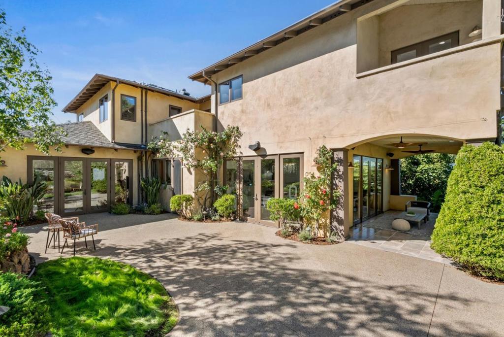 Spectacular contemporary farmhouse in desirable Menlo Park, delivering the epitome in modern lifestyle. Light and bright interior with large volumes. Every room has plentiful sunshine and beautiful views. Exquisite craftsmanship and quality finishes. Custom travertine stone floors, wooden beam ceilings, handcrafted Waterworks tiles, rich wood, and extensive built-in cabinetry. Chefs kitchen with professional Thermador gas stove and built-in appliances, honed stone counter tops, large island, and built-in breakfast nook. Living/dining room combination seamlessly opens to patio for entertaining. Separate family room with outside entrance, and hallway bathroom. 4 generous bedrooms and 1 office room upstairs bathed by natural light. Vintage-inspired shared bath with clawfoot tub. Stunning primary retreat with vaulted ceilings, Zen bathroom & walk-in closet. Very private, with gorgeous mature landscaping and an abundance of patios and balconies. Heated 50+ feet lap pool and hot tub. Detached 2-car garage. Air conditioning and radiant heat. Bike to schools, Stanford, and Sand Hill Road. Easy access to shopping, commute routes & leading tech campuses such as Apple, Google and Meta. Award-winning Las Lomitas schools.