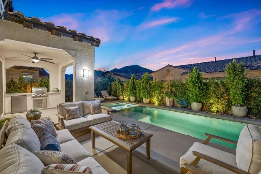 Nestled behind the gates of Floresta, this home stands as one of the most exquisite and fully upgraded residences in the entire community. This 3-bedroom, 2.5-bath masterpiece spans 2,302 sq. ft. of refined luxury, where every inch has been meticulously reimagined with designer precision, cutting-edge upgrades, and a seamless blend of sophistication and comfort.Step inside to discover an open-concept floor plan with soaring ceilings, warm natural light, and elegant finishes throughout. The great room centers around a beautifully tiled feature wall and flows effortlessly into a chef's kitchen that redefines modern elegance. Recently remodeled from top to bottom, it features premium stainless steel appliances--including double ovens, a 6-burner gas cooktop, built-in drawer microwave, and wine refrigerator--anchored by a massive quartz island ideal for entertaining. Custom cabinetry, designer lighting, and detailed tile work elevate the space into a true showpiece.The outdoor living area feels like a private resort. Enjoy a newly upgraded pebble-finish pool and spa, built-in BBQ with refrigerator, two covered patios with electric awnings, and low-maintenance landscaping framed by stunning mountain views and vivid sunsets. Every detail was thoughtfully curated for relaxation and style.The primary suite is a true retreat, featuring a spa-inspired bathroom with a soaking tub, glass-enclosed shower, dual vanities, and an oversized walk-in closet. The two additional bedrooms share a beautifully remodeled Jack and Jill bath, offering guests or family members both comfort and privacy.Additional highlights include a finished 2-car garage with custom cabinetry & epoxy flooring, a separate golf cart garage, tankless water heater, upgraded lighting and flooring throughout, and whole-home smart features.Located within the highly rated Desert Sands Unified School District and just moments from world-class golf, dining, and shopping, this property is ideal as a full-time residence, luxury vacation home, or high-end investment.This is more than just one of the best homes in Floresta--it's the benchmark for modern desert living.