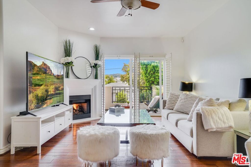 Built in 2007, this light and bright unit is in a secured, 8 unit building with only one common wall is above ground level with a beautiful South facing balcony to enjoy the trees and mountain views. Enjoy the open concept living space with wood floors, high ceilings, custom wood shutters, gas fireplace, dining area and 2 bedrooms on opposite sides of the unit. The well appointed kitchen include imported ebony granite counters, breakfast counter, custom cherry wood cabinets and Viking stainless steel appliances. On the right, the spacious primary bedroom suite includes a large walk-in closet and a luxurious bathroom with travertine counters, dual sinks and a separate walk-in shower and bath tub. On the opposite side is the 2nd bedroom with a large mirror doors closet. Right next to it is a stackable washer and dryer and linen closet. A second full bathroom completes this gorgeous unit. This beautiful building enjoys a panoramic rooftop deck with 360 views and a fire pit. Secured 2 tandem parking spots on ground level make elevator access easy. Close to Beeman Park, major film, TV, and music studios, Gelsons and Campbell hall with easy access to downtown, Ventura Boulevard, and everything that Studio City has to offer.