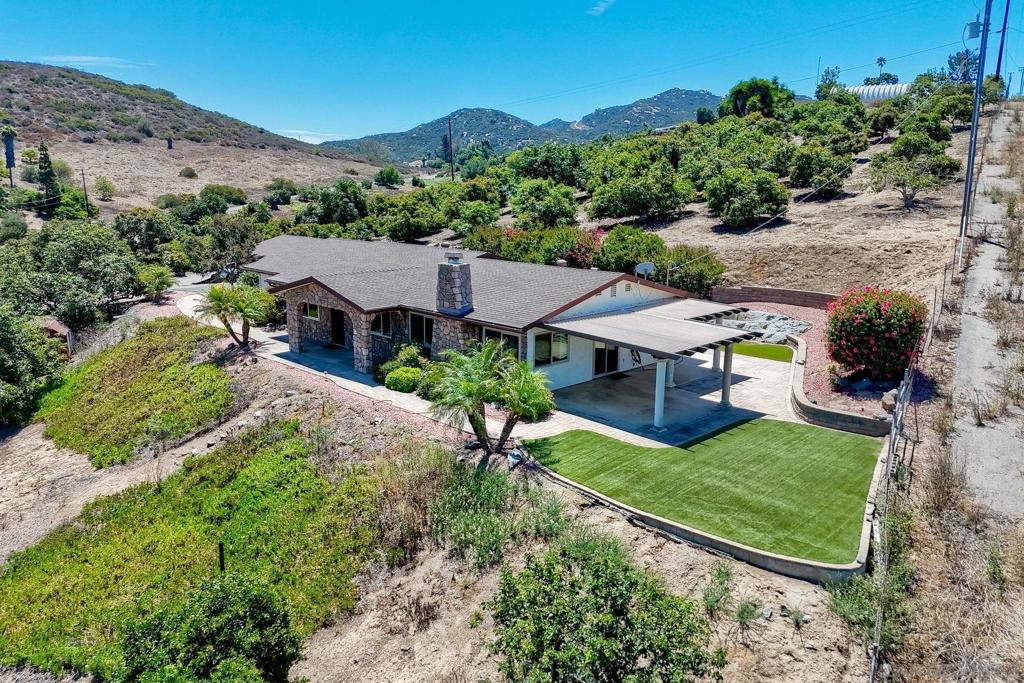 ONE-OF-A-KIND AVOCADO GROVE RETREAT! SINGLE-STORY CUSTOM HOME atop a hill with PANORAMIC VIEWS OF 500+ AVOCADO TREES! GREAT ROOM ideal for entertaining, featuring DUAL PANED WINDOWS, TRAVERTINE FLOORS, OVERSIZED ISLAND, and a CHEF’S KITCHEN WITH CUSTOM CABINETRY AND PANELED REFRIGERATOR AND DISHWASHER. Spacious PRIMARY SUITE overlooks the PEACEFUL ORCHARD. Rare opportunity to own a WORKING AVOCADO ORCHARD WITH A VIEW-FILLED RESIDENCE! ONE-OF-A-KIND AVOCADO GROVE RETREAT! Welcome to your private paradise — a beautifully remodeled SINGLE-STORY CUSTOM HOME perched atop a hill with SERENE PANORAMIC VIEWS OF 500+ THRIVING AVOCADO TREES! This special property offers the best of INDOOR-OUTDOOR CALIFORNIA LIVING, with an OPEN-CONCEPT GREAT ROOM ideal for entertaining, featuring TRAVERTINE FLOORS, a CUSTOM OVERSIZED ISLAND, and a CHEF’S KITCHEN WITH SOFT-CLOSE CABINETRY AND PANELED REFRIGERATOR AND DISHWASHER FOR A SEAMLESS CUSTOM LOOK. Enjoy year-round comfort and energy efficiency with DUAL-PANED WINDOWS THROUGHOUT. The spacious PRIMARY SUITE overlooks the PEACEFUL ORCHARD, offering a TRANQUIL RETREAT. A rare opportunity to own a WORKING AVOCADO ORCHARD WITH A VIEW-FILLED RESIDENCE — don’t miss it!