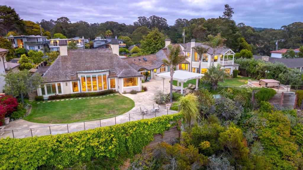 This stunning property is for the selective few. The ones who require the delicate balance of privacy while still entertaining friends & family -The ones who understand that you dont just move to Rio del Mar, you acquire it! The lifestyle begins as you enter this gated estate & the unique architecture welcomes you home each day. This house is situated on the bluffs of Rio del Mar, showcasing the dramatic views of the Monterey Bay coastline. The beautiful kitchen has an amazing amount of counter space and a large island as it flows into the living room, displaying 1 of 4 spectacular fireplaces. This striking home also boasts a game room, fully equipped fitness room and steam bath. The entire second floor is a retreat that is set aside specifically for you. Begin each day with a cup of coffee on your private balcony while taking in the view & end each day under the stars. The fireplace solidifies the perfection of this room; but its the walk-in closet that will leave you breathless.