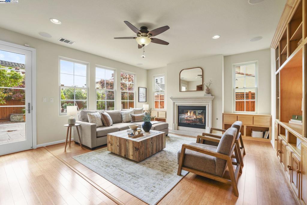 Welcome to this Model 9 Plan in the beautiful Bayport neighborhood of Alameda. Situated at the end of a quiet street, this 4-bedroom, 3-bathroom corner-lot home offers a bright and flexible layout. A soaring two-story entry opens to wood floors throughout and spacious living areas. The open kitchen with center island flows into the family room, where a fireplace and custom built-in shelving create a warm focal point. A formal living room connects seamlessly to the dining room, ideal for gatherings and entertaining. The first floor also includes a bedroom and full bath, perfect for guests or multi-generational living. Upstairs, a versatile loft offers space for an office, playroom, or lounge. The primary suite features a walk-in closet, jacuzzi tub, and separate shower, with two additional bedrooms and a full bath completing the second level. Lush landscaping surrounds this corner property, adding privacy and curb appeal. Located in Alameda’s sought-after Bayport community, you’ll be near parks, schools, Alameda Landing, Webster Street, the ferry, and convenient access to Oakland and beyond.
