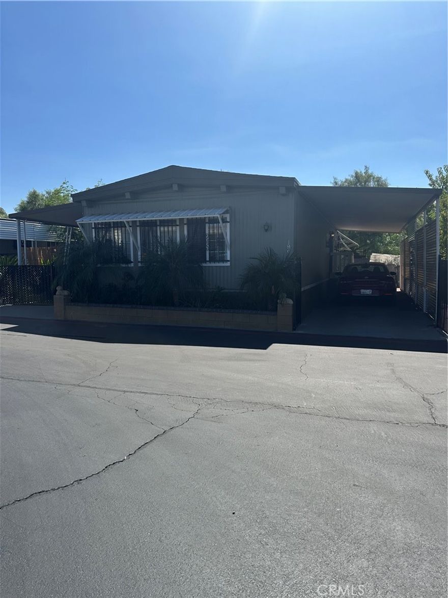 this 3 bedroom 2 bath manufactured home in a tidy hemet mobile home park features central ac and heating, an update kitchen with laminate flooring, laundry hooks ups  and a open, spacious layout. Enjoy a three -car driveway, front patio, and a low-maintenance backyard with detached storage adds privacy and extra space.Park amenities include a community pool, recreation room , and guest parking. A practical , comfortable home ideal for modern living in a friendly park setting