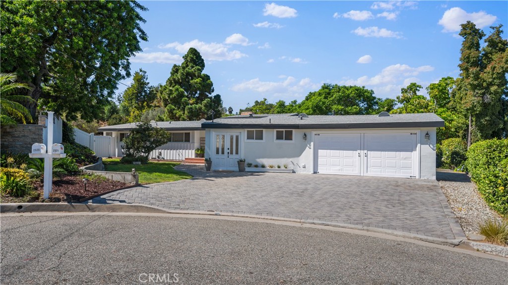 Your Mid Century Ranch Home Oasis Awaits! Welcome to 2321 Carriage Drive, a captivating 4-bedroom, 3-bathroom home situated in the peaceful equestrian community of Rolling Hills Estates. With 2,346 sq. ft. of living space on a generous 25,000 sq. ft. lot, this one-level ranch style home offers an open floor plan ideal for entertaining with plenty of space to mozy around in. Sunlight pours through large windows, seamlessly blending indoor and outdoor living, while the authentic charm of open-beamed ceilings and oak hardwood floors elevates the main living areas. The updated kitchen, featuring quartz countertops, white cabinetry, and new appliances, flows effortlessly into the dining and family rooms, architecturally centered by the original brick fireplace. The spacious primary suite serves as a private retreat with an ensuite bath and walk-in closet. Additional bedrooms offer versatility for family, guests, or a home office. Outside, enjoy your own private oasis with a large deck, horse stable, citrus orchard, and stunning views. Direct access to scenic horse and hiking trails makes this property a haven for equestrians and nature lovers. Located in the award-winning Palos Verdes School District and offering easy access to shopping and freeways, this home is a rare opportunity to own a piece of classic California living in a prime location.