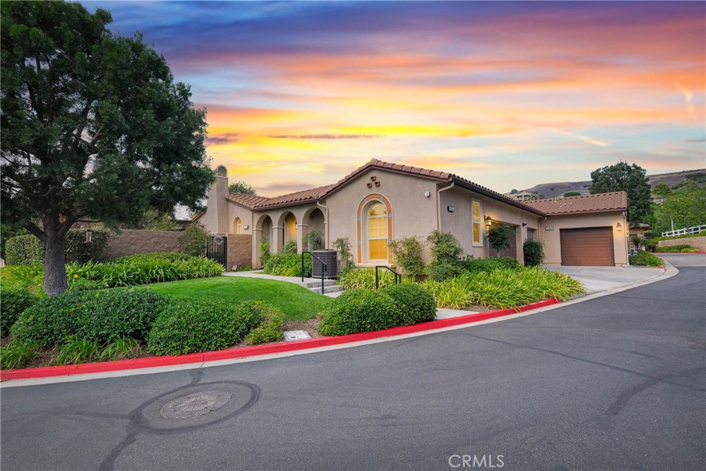 Immaculate Single-Story Home in Prestigious Villagio Community. Welcome to this beautifully maintained, private, single-story town home located in the heart of Yorba Linda’s sought-after Villagio community. Surrounded by top-rated schools and miles of scenic horse and walking trails, this 1,714 sq. ft. residence combines elegance, comfort, and convenience. Step inside to soaring ceilings, crown molding, and gorgeous hardwood flooring throughout. The versatile floorplan offers 3 bedrooms (one currently used as a den/office without a closet) and 2 bathrooms. The chef’s kitchen is a showstopper, featuring granite countertops with full backsplash, center island with bar seating, tremendous cabinet space, and premium stainless-steel appliances—including Samsung refrigerator, double ovens, gas cooktop, microwave, and dishwasher. Entertain with ease in the formal living room with fireplace, adjoining dining area, and optional den/office that could easily serve as a third bedroom. The primary suite offers a walk-in closet, private sliding glass door to the backyard, and a spa-like bathroom with dual vanities, soaking tub, and separate shower. Additional highlights include a convenient inside laundry room with sink and cabinetry, a newly upgrades include: AC system, Engineered hardwood flooring throughout, wolfer stove and range hood, along with California Faucets fixtures in the kitchen and bathrooms including shower heads, Custom rolling pull-out kitchen cabinet drawers, Custom closet organizer in each bathroom, water softener and more. Enjoy the functionality of two single-car garages, both upgraded with epoxy flooring—one with direct home access and the other with a private door to the backyard. The outdoor living space is newly custom built for both entertaining and everyday relaxation, featuring a custom outdoor kitchen with sink, prep counter, stainless-steel storage and fireplace. Stone accents, tiled flooring, raised planters with fruit trees, and a spacious dining area with umbrella create a seamless extension of the home. Community HOA dues include use of the sparkling pool and spa, plus exterior home maintenance—including roof, paint, and termite coverage. With no Mello-Roos and award-winning Placentia-Yorba Linda schools (Mabel Paine Elementary, Yorba Linda Middle, and walking distance to Yorba Linda High), this home truly has it all.