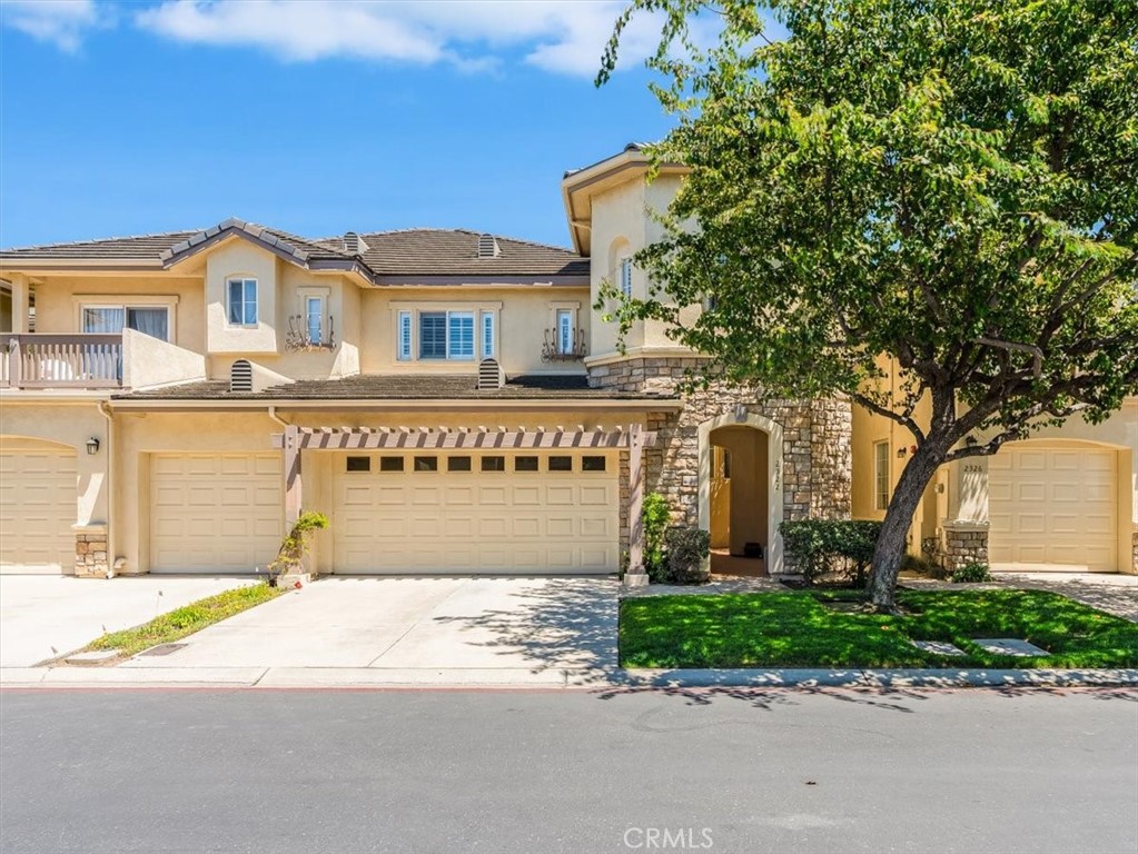 Spacious and inviting, this 4-bedroom, 2.5-bath, 2,280 sq. ft. townhome is the only four-bedroom unit in the highly desirable Somerset Garden community, offering resort-style amenities including a sparkling pool, clubhouse, and putting green. The main level features an open, light-filled floor plan with a soaring 20-foot vaulted ceiling in the living room, a marble-encased fireplace, and seamless access to the dining area. The well-appointed kitchen includes a breakfast bar, stainless steel appliances, and a leased reverse osmosis water filtration system. Patio access from both the living room and the main-level primary suite invites easy indoor-outdoor living. The primary suite boasts a luxurious bath with a soaking tub, separate shower, and private commode. A laundry room off the kitchen and a convenient half bath complete the first floor. Upstairs, you’ll find a versatile loft, three generously sized bedrooms, and a full bath. One bedroom is currently configured as an expansive walk-in closet but can easily be restored to a traditional bedroom. Additional highlights include a whole-house leased water purifying system, plantation shutters throughout, wood flooring on the main level, tile in the kitchen, baths, and laundry, and plush carpeting in the upstairs bedrooms and staircase. A two-car garage provides ample parking and storage. Ideally located near golf courses, shopping, dining, and just a short drive from beautiful beaches and world-class wineries, this rare offering blends comfort, convenience, and style.