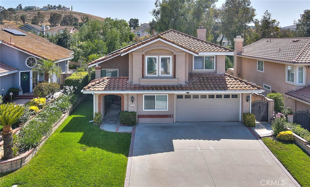 Nestled in one of the most sought-after neighborhoods of North Chino Hills, this stunning pool home offers effortless elegance and comfort. From the moment you walk in, you’ll be greeted by soaring vaulted ceilings and sunlit spaces that set a welcoming tone. The formal living and dining areas are generous in size—perfect for hosting guests or enjoying family gatherings. The dine-in kitchen features sleek stainless steel appliances and abundant counter and cabinet space, ideal for casual meals or culinary creations. Unwind in the cozy family room anchored by a warm fireplace, or escape to your backyard oasis, complete with a sparkling pool and spa that promise endless sun-soaked afternoons. Upstairs, the spacious primary suite includes a dual-sink vanity, a large soaking tub/shower combo, and a walk-in closet. Three additional bedrooms and a full bath complete the upper level—offering room for everyone. You will appreciate having low electric bills with the leased solar panels, buyer to assume the remaining loan. Conveniently located in the vibrant heart of Chino Hills, you'll be just minutes from top-rated schools, premier shopping, and great dining. This is more than a house—it's your forever home waiting to be discovered.