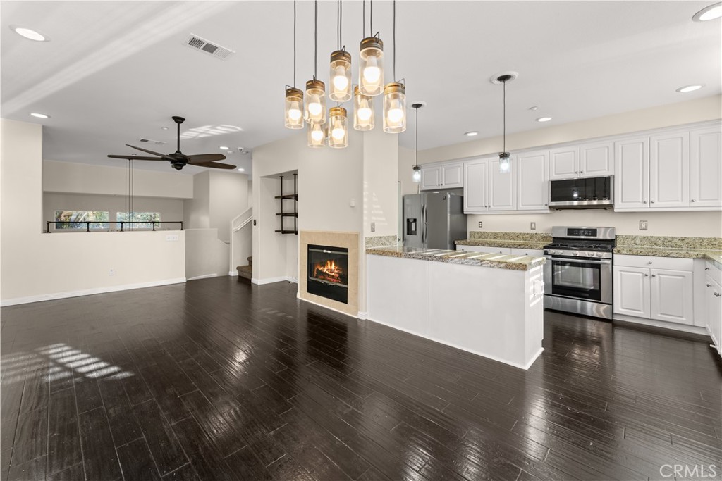 This beautifully maintained tri-level home in the gated Willow Haven community offers a floor plan that shows like a model, with many updates and a blend of comfort and style. Entry level leads into a versatile living area with new laminate flooring (recently repainted throughout). Middle level features a family room with a cozy fireplace, kitchen, walk-in pantry, granite countertops, new faucets & lighting. All three bedrooms located on the top level, each with new carpeting and ceiling fans. Laundry is upstairs for convenience. Bathrooms have been refreshed with new faucets and toilets. Plantation shutters throughout bring in natural light while providing privacy. Exterior features & Community Amenities include attached 2-car direct-access garage, plus open guest parking in front of the unit, Private front patio — ideal for morning coffee or relaxing outdoors, gated community with resort-style amenities: pool, spa, recreation room, and play area. This home has convenient access to freeways (I-215), shopping, dining, medical facilities, and schools.